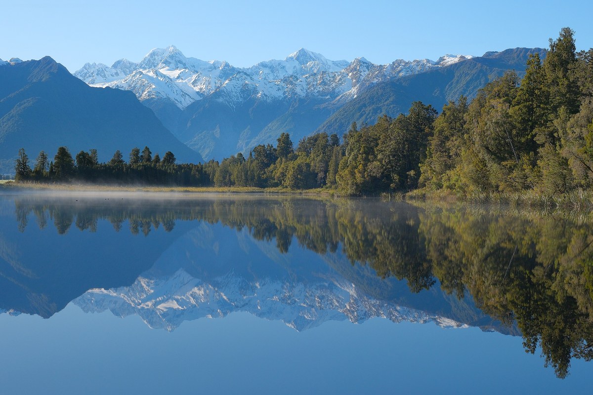 Mountains reflected in the still water of Lake Matheson