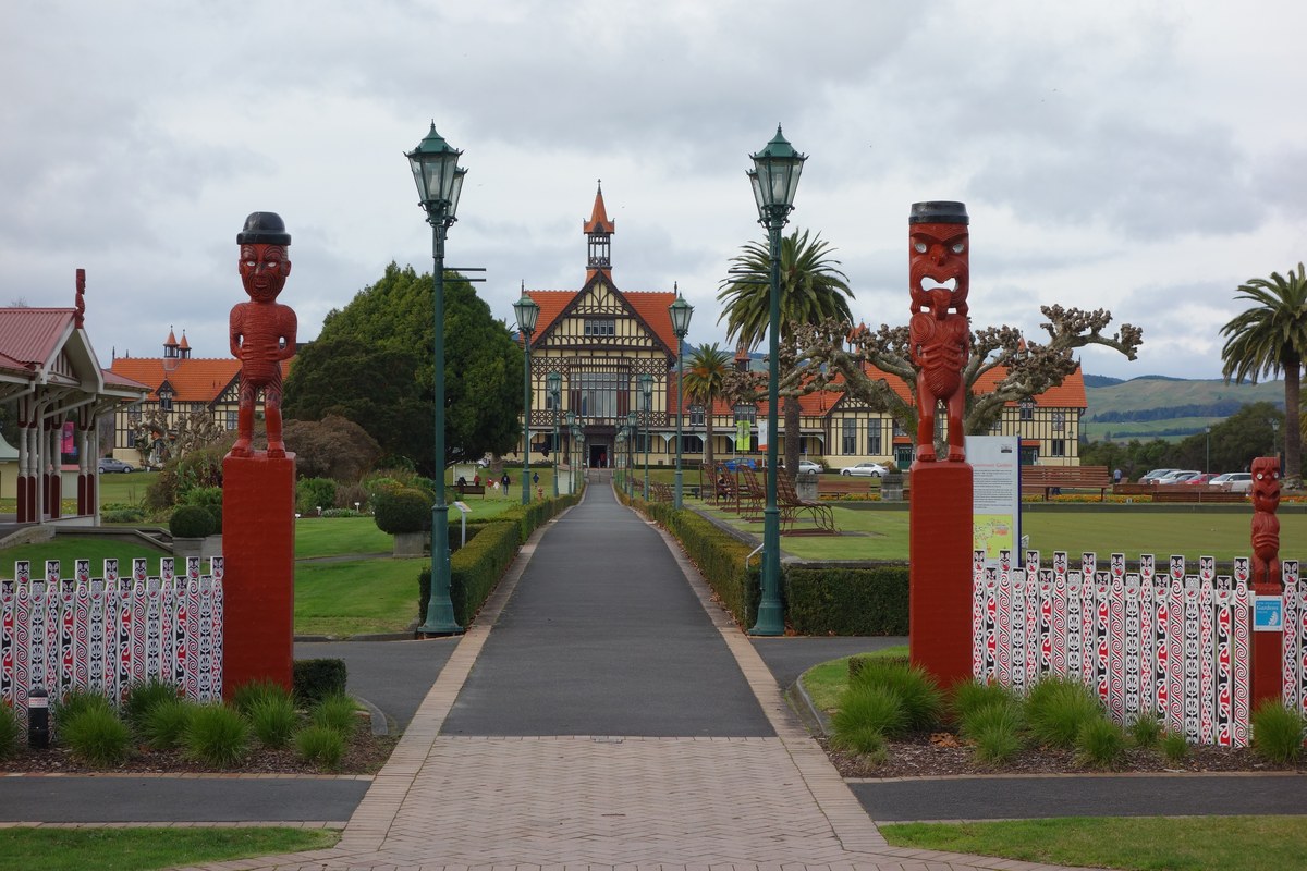 Carved posts framing the path to the historic Bath House in Rotorua's Government Gardens